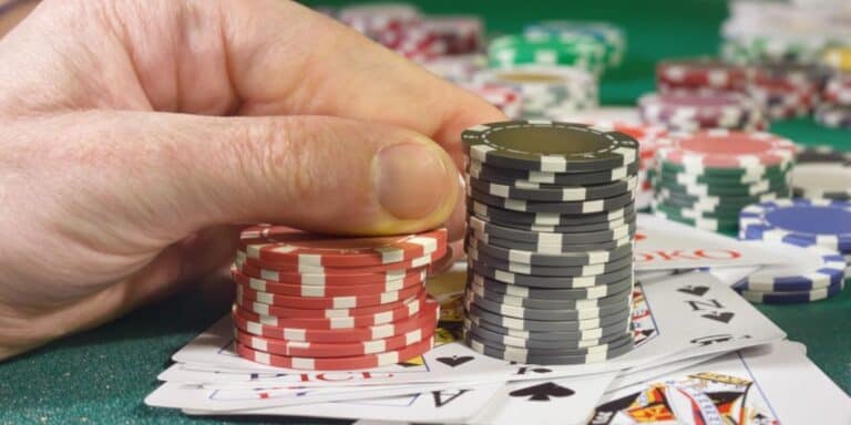 Man placing bet with chips and cards