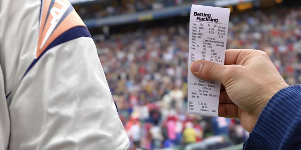 Player analyzing game stats for betting.